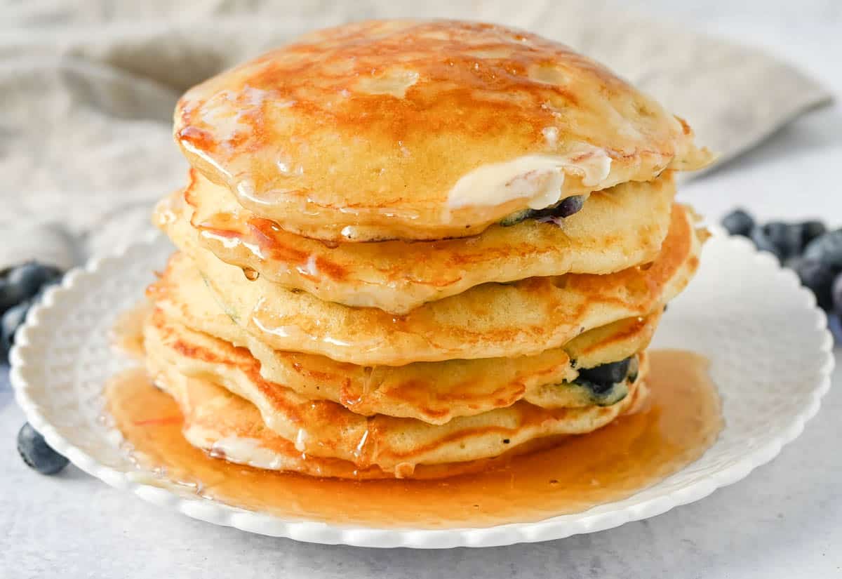 Homemade fluffy blueberry pancakes are made with fresh blueberries and are the best buttermilk blueberry pancakes ever! These are easy blueberry pancakes made from scratch. 