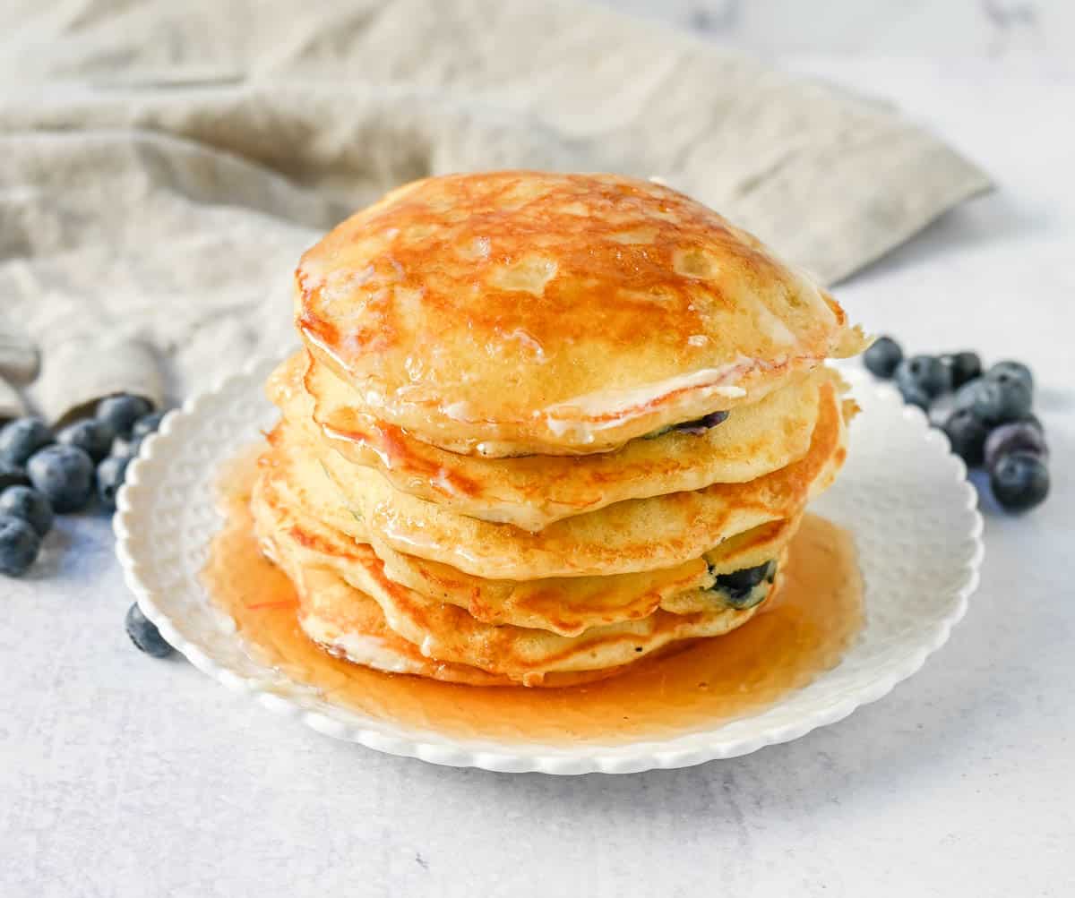 Homemade fluffy blueberry pancakes are made with fresh blueberries and are the best buttermilk blueberry pancakes ever! These are easy blueberry pancakes made from scratch. 