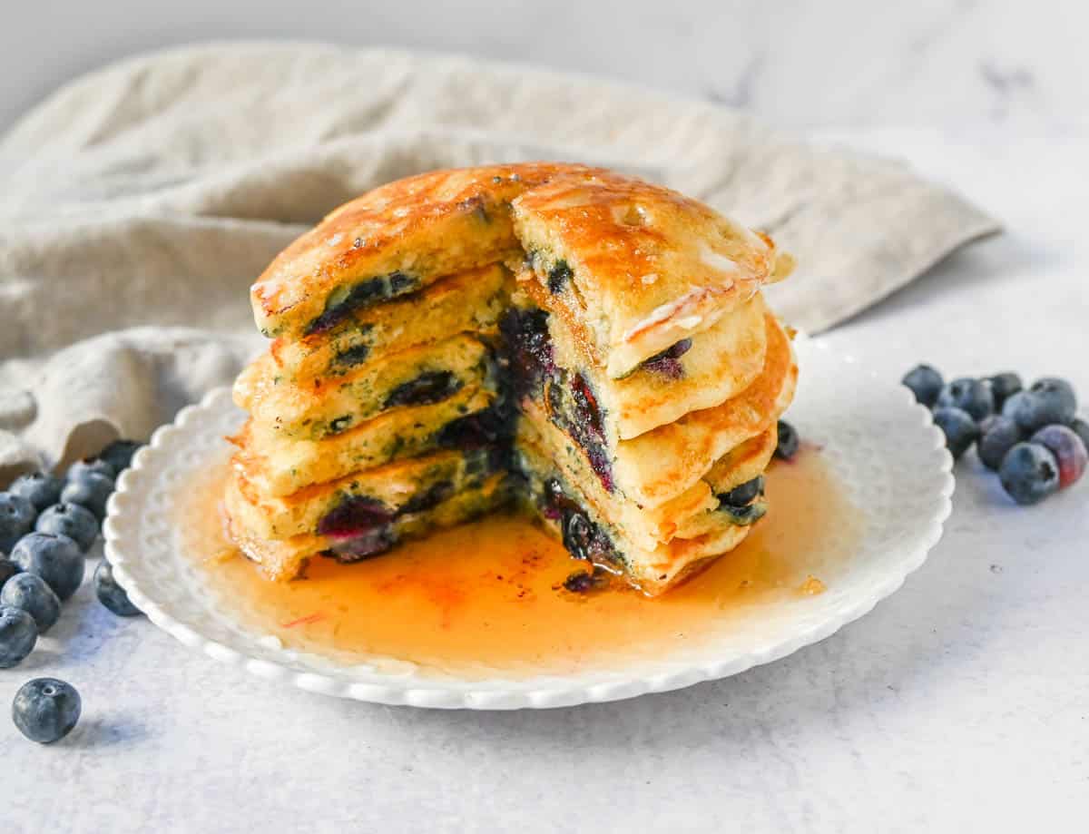 Homemade fluffy blueberry pancakes are made with fresh blueberries and are the best buttermilk blueberry pancakes ever! These are easy blueberry pancakes made from scratch. 