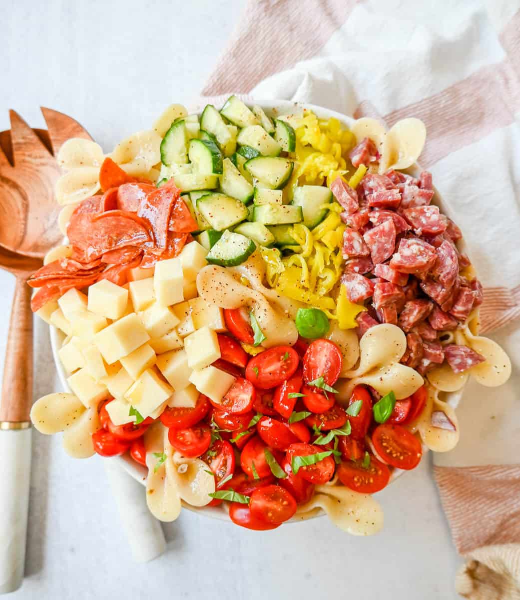 How to make the best pasta salad with Italian meats, cheese, pasta, and vegetables, all tossed with a homemade creamy red wine vinaigrette. This is such an easy, popular pasta salad recipe.