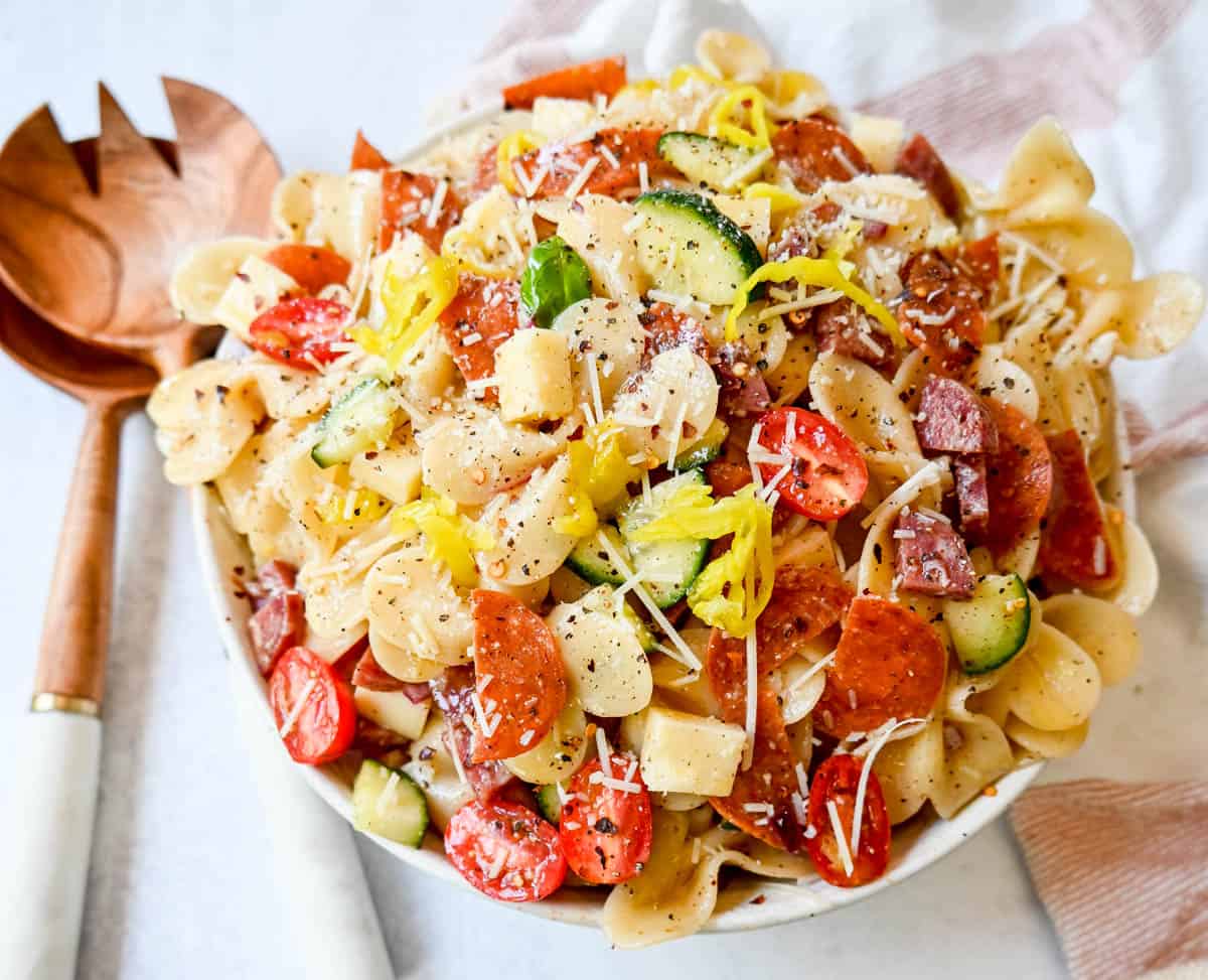 How to make the best pasta salad with Italian meats, cheese, pasta, and vegetables, all tossed with a homemade creamy red wine vinaigrette. This is such an easy, popular pasta salad recipe.