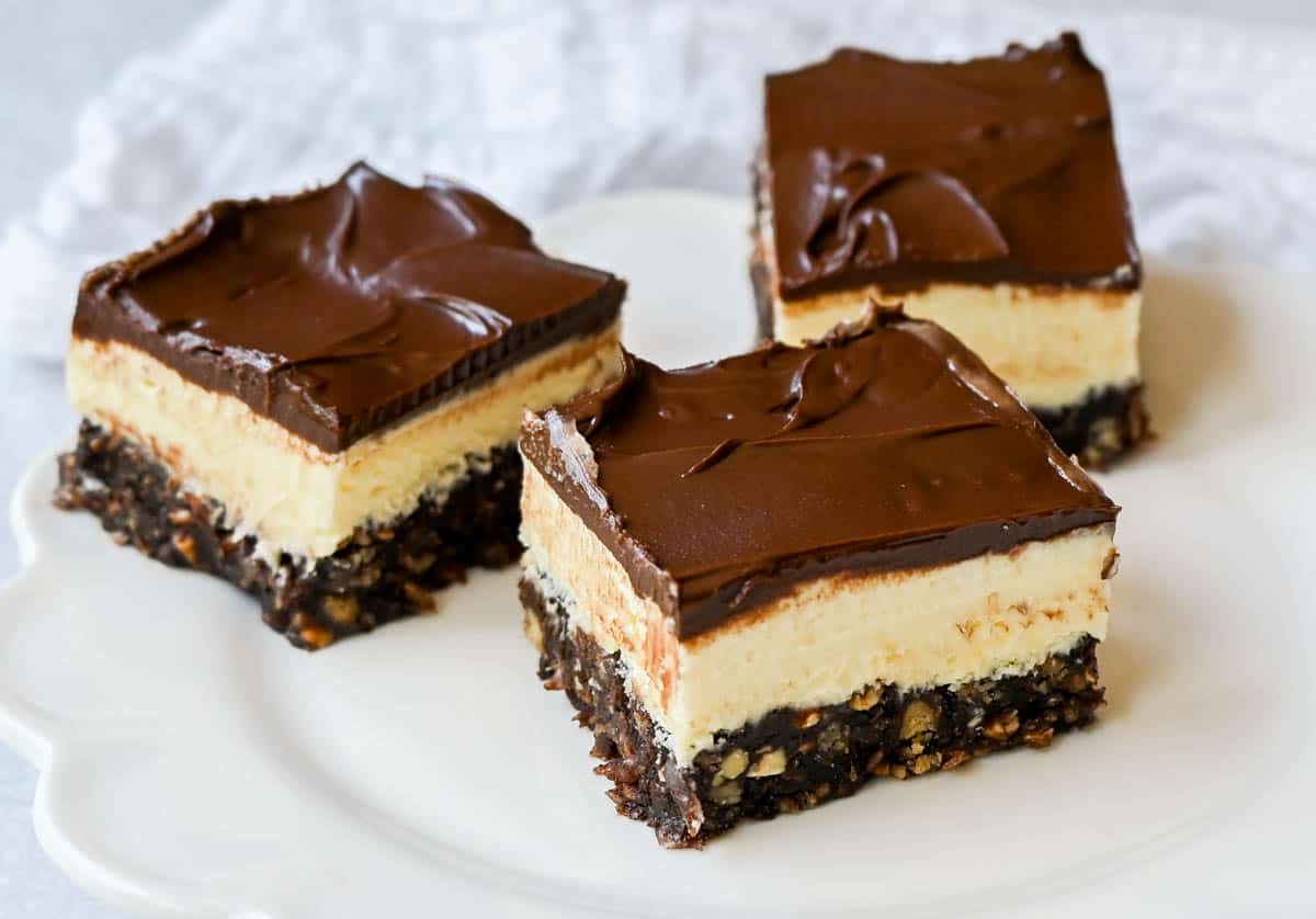 Rich and fudgy Nanaimo bars are the perfect no bake dessert. A chocolate, graham cracker, almond, and coconut base layer is topped with a creamy custard filling and chocolate ganache. You’ll be hooked on this classic Canadian treat!