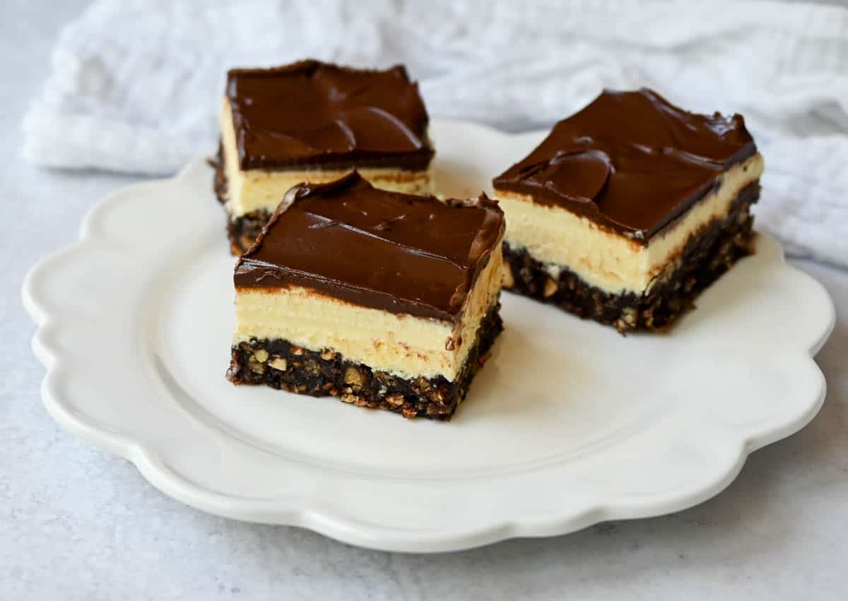 Rich and fudgy Nanaimo bars are the perfect no bake dessert. A chocolate, graham cracker, almond, and coconut base layer is topped with a creamy custard filling and chocolate ganache. You’ll be hooked on this classic Canadian treat!