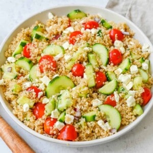 A light and healthy quinoa salad made with quinoa, crunchy cucumbers, fresh tomatoes, crisp red onion, and tangy feta tossed in a red wine vinaigrette. The perfect side dish or healthy meal!