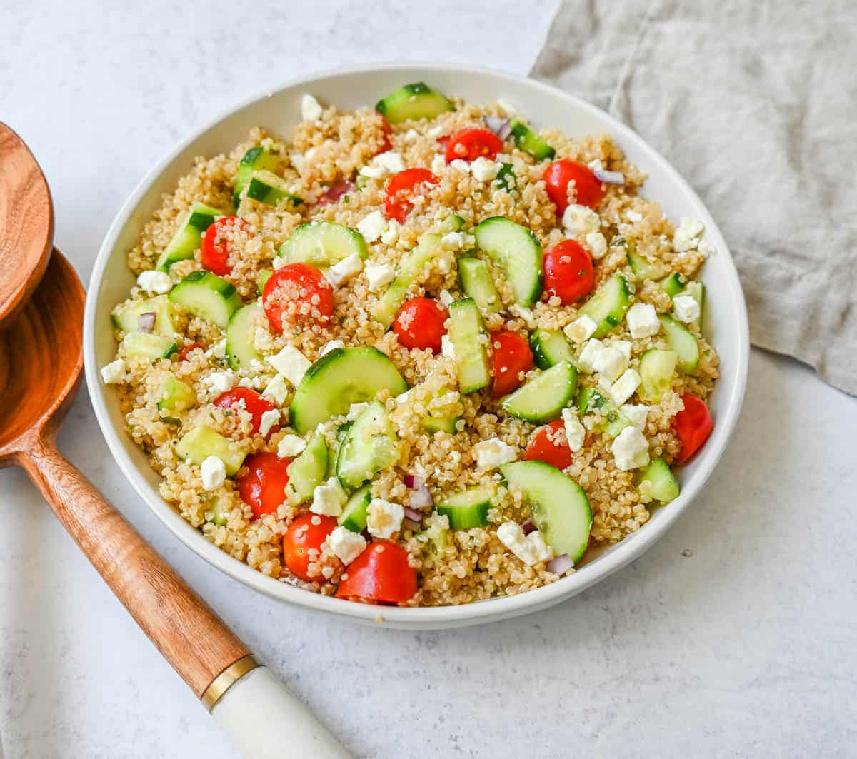 A light and healthy quinoa salad made with quinoa, crunchy cucumbers, fresh tomatoes, crisp red onion, and tangy feta tossed in a red wine vinaigrette. The perfect side dish or healthy meal!