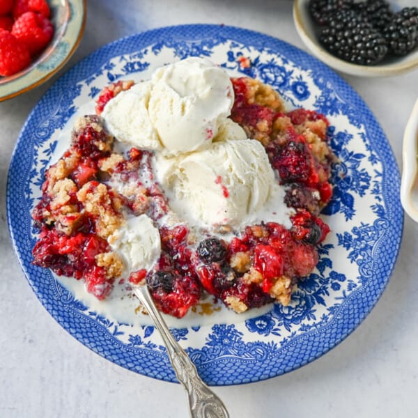 This homemade Berry Crisp is made with fresh Raspberries, Blackberries, Strawberries, and Blueberries and topped with a buttery crumble topping. This berry crumble is the perfect summer dessert.