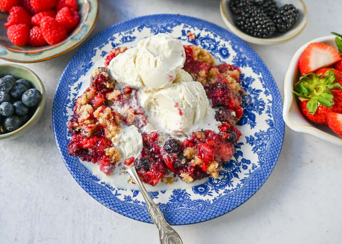 This homemade Berry Crisp is made with fresh Raspberries, Blackberries, Strawberries, and Blueberries and topped with a buttery crumble topping. This berry crumble is the perfect summer dessert.