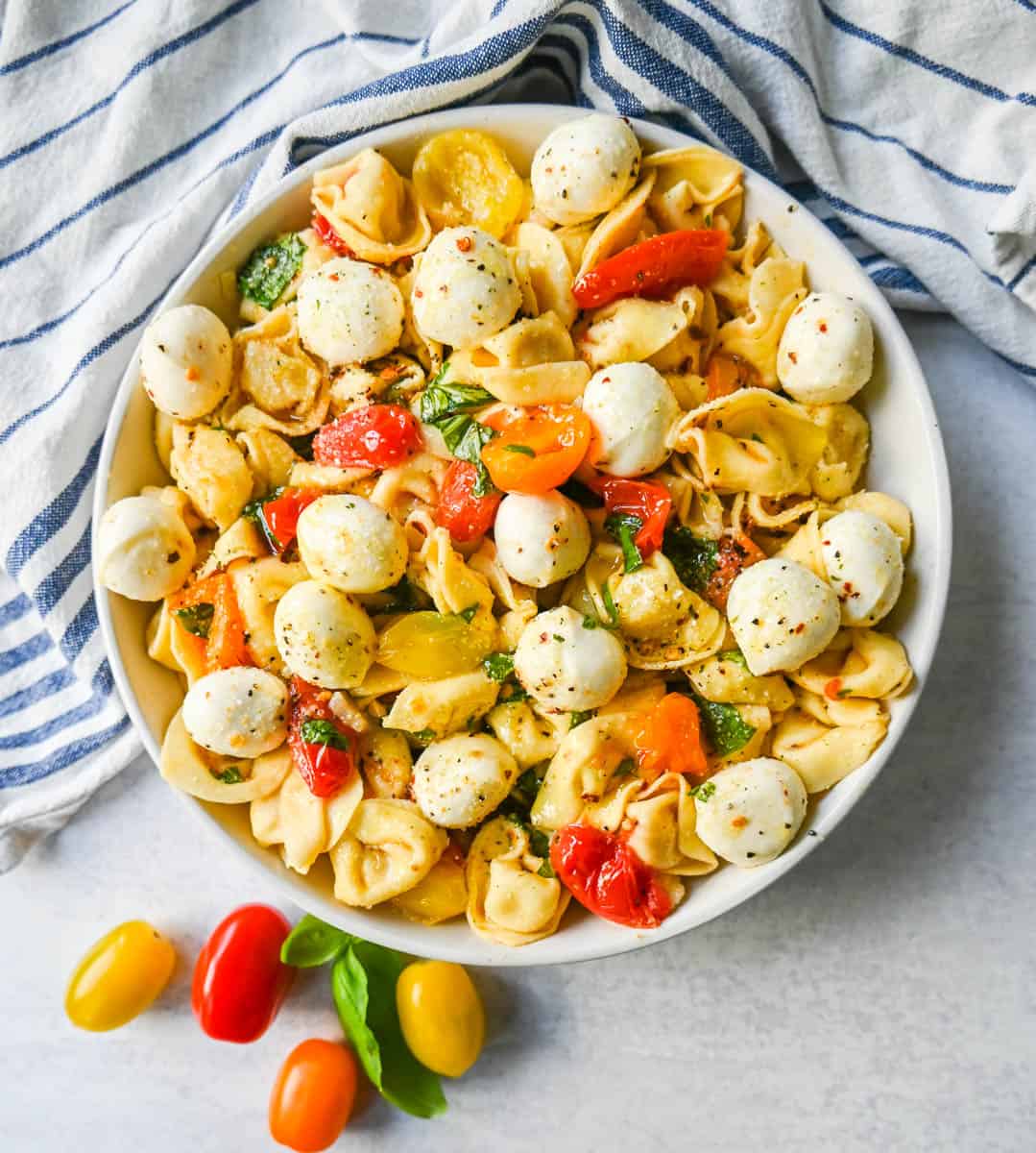 This Caprese Tortellini is made with cheese Tortellini tossed with sauteed garlic and tomatoes in extra virgin olive oil, fresh basil, and fresh mozzarella and spices. This fresh tortellini caprese pasta is perfect for summer!