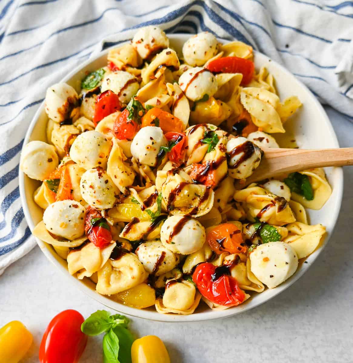 This Caprese Tortellini is made with cheese Tortellini tossed with sauteed garlic and tomatoes in extra virgin olive oil, fresh basil, and fresh mozzarella and spices. This fresh tortellini caprese pasta is perfect for summer!