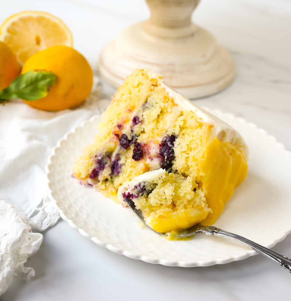 Light, fluffy, moist lemon cake with with fresh blueberries with a sweet cream cheese frosting. This is the best lemon blueberry cake recipe!