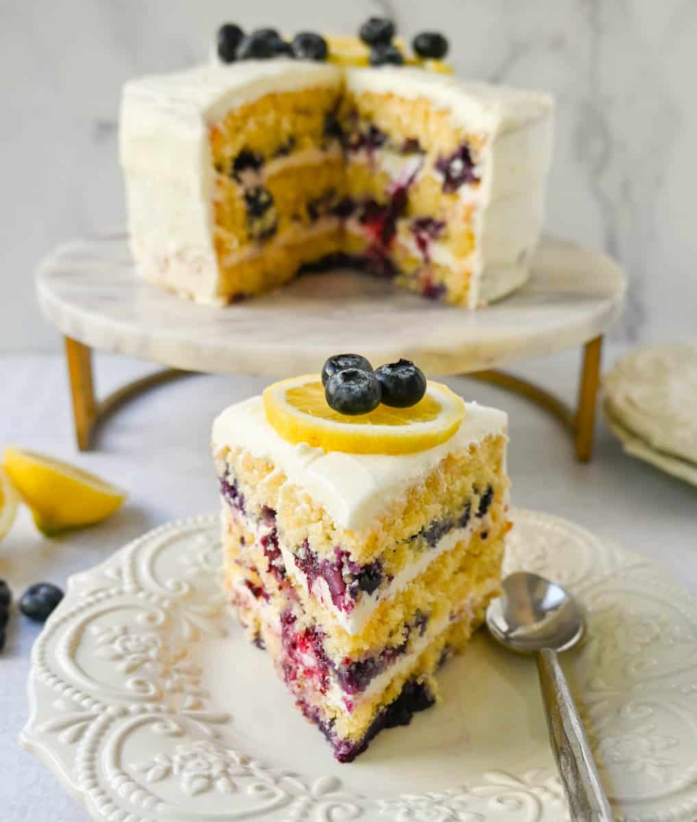 Light, fluffy, moist lemon cake with with fresh blueberries with a sweet cream cheese frosting. This is the best lemon blueberry cake recipe!