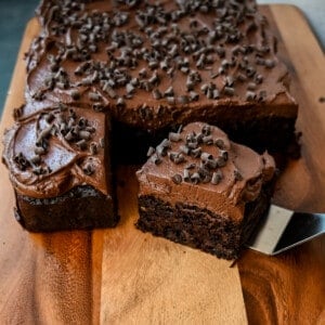 How to make the best chocolate zucchini cake with chocolate frosting. This frosted chocolate zucchini cake is the most moist, rich chocolate cake with the most decadent chocolate frosting. You will not even realize you are eating zucchini!