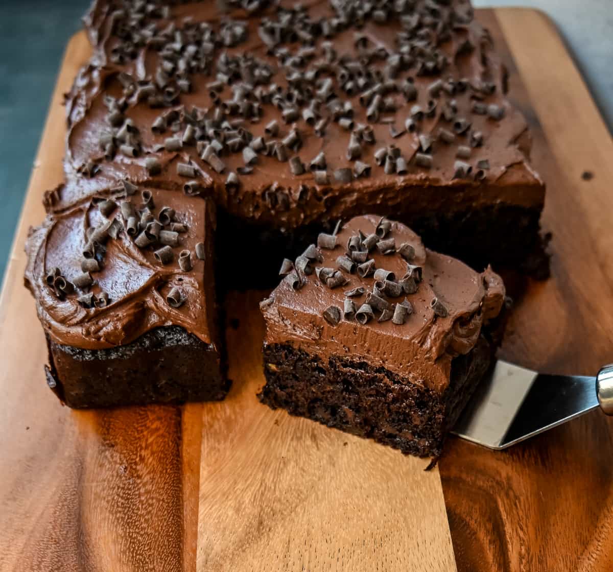 How to make the best chocolate zucchini cake with chocolate frosting. This frosted chocolate zucchini cake is the most moist, rich chocolate cake with the most decadent chocolate frosting. You will not even realize you are eating zucchini!