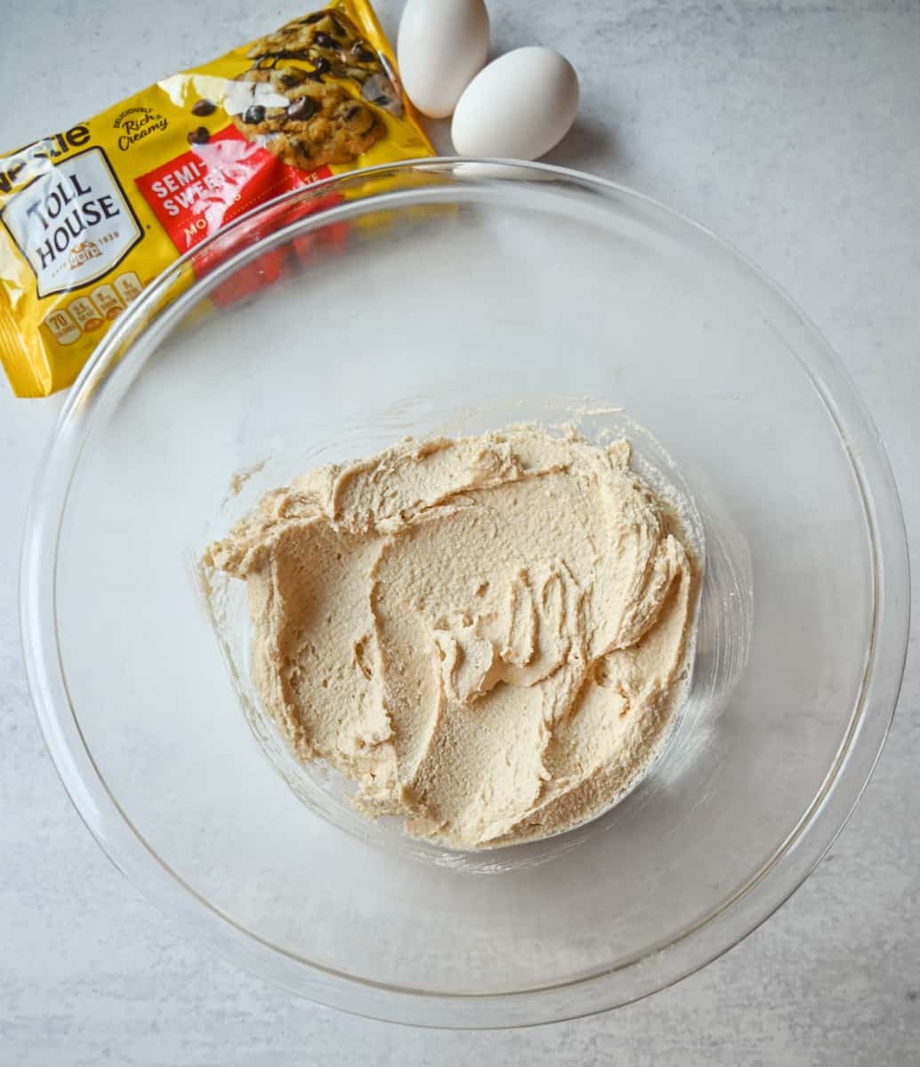 Beating together butter and sugars to make Nestle Toll House cookies