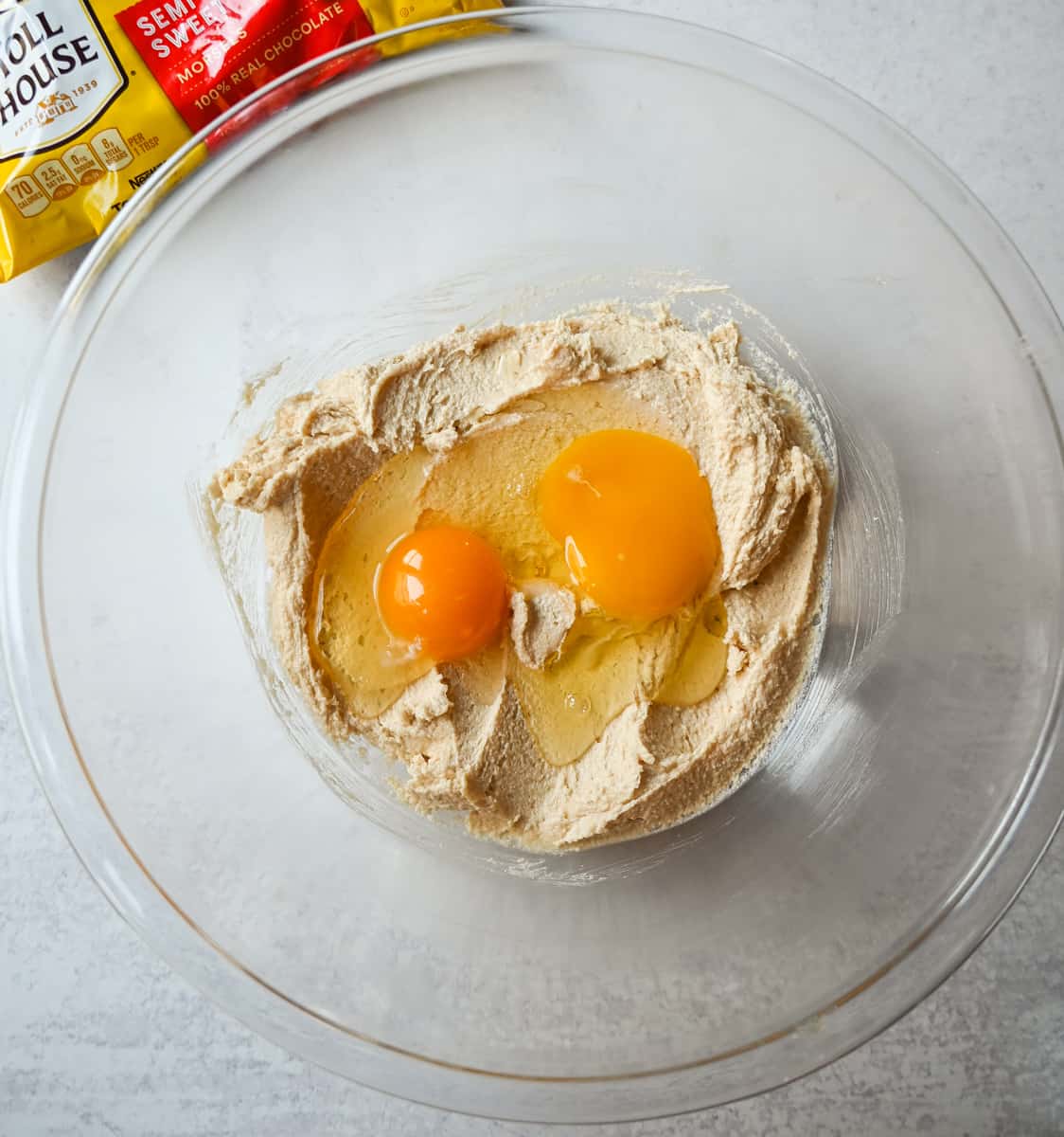 Beating eggs into Nestle Toll House cookie dough