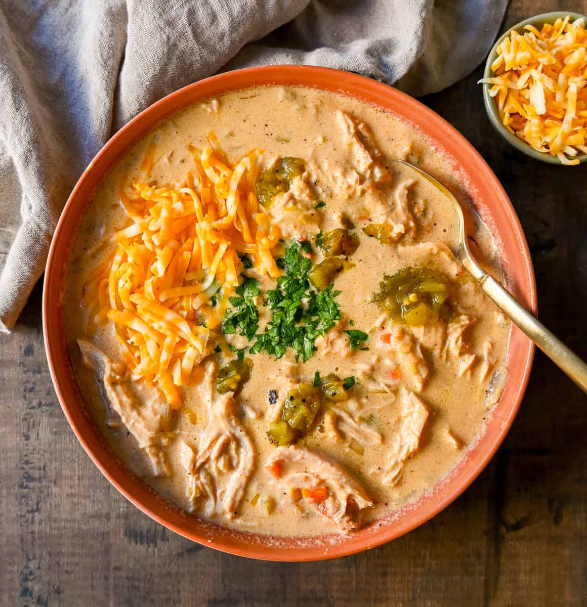Rich, cheesy chicken queso soup made with three types of cheeses, tender chicken, green chiles, and spices—all the flavors of cheese queso but in a soup! The creamiest, most flavorful Chicken Cheese Soup.