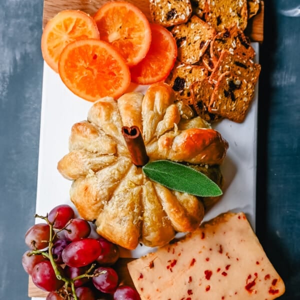 Pumpkin Shaped Baked Brie Puff Pastry. This festive Fall Pumpkin Baked Brie is the perfect appetizer or centerpiece for your charcuterie board. Flaky puff pastry baked with creamy brie cheese and pumpkin butter or fig jam is the perfect salty sweet combination.