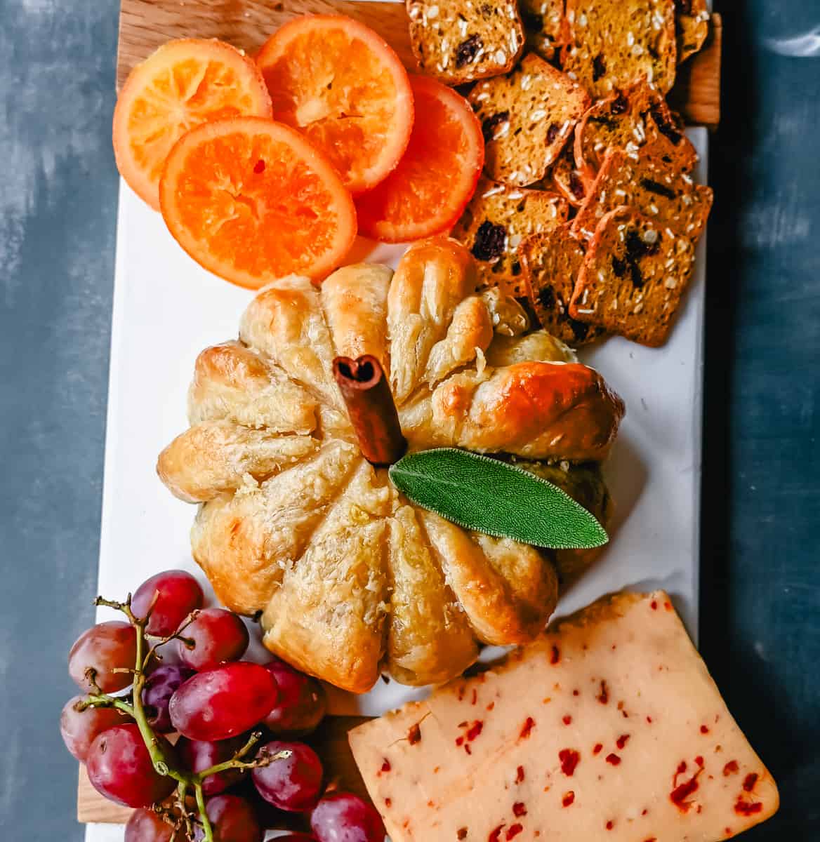 Pumpkin Shaped Baked Brie Puff Pastry. This festive Fall Pumpkin Baked Brie is the perfect appetizer or centerpiece for your charcuterie board. Flaky puff pastry baked with creamy brie cheese and pumpkin butter or fig jam is the perfect salty sweet combination.