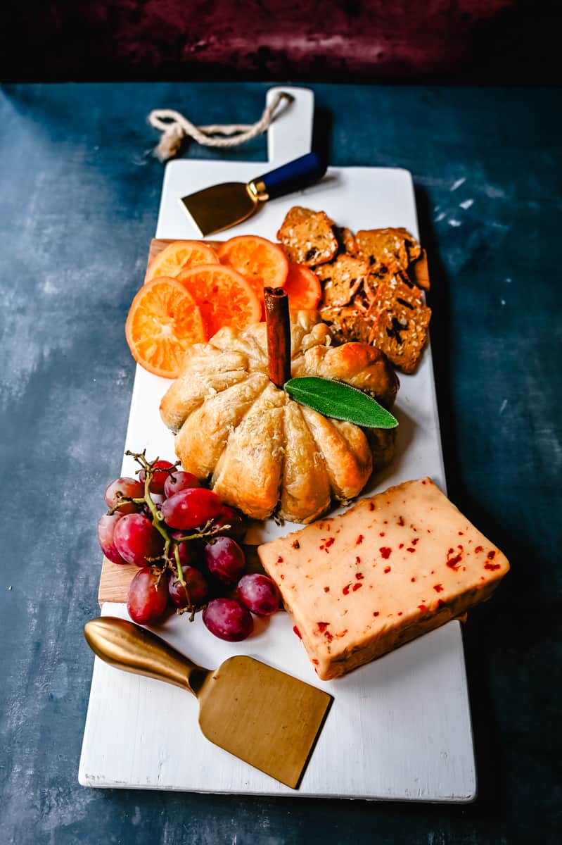 Pumpkin Shaped Baked Brie Puff Pastry. This festive Fall Pumpkin Baked Brie is the perfect appetizer or centerpiece for your charcuterie board. Flaky puff pastry baked with creamy brie cheese and pumpkin butter or fig jam is the perfect salty sweet combination. 