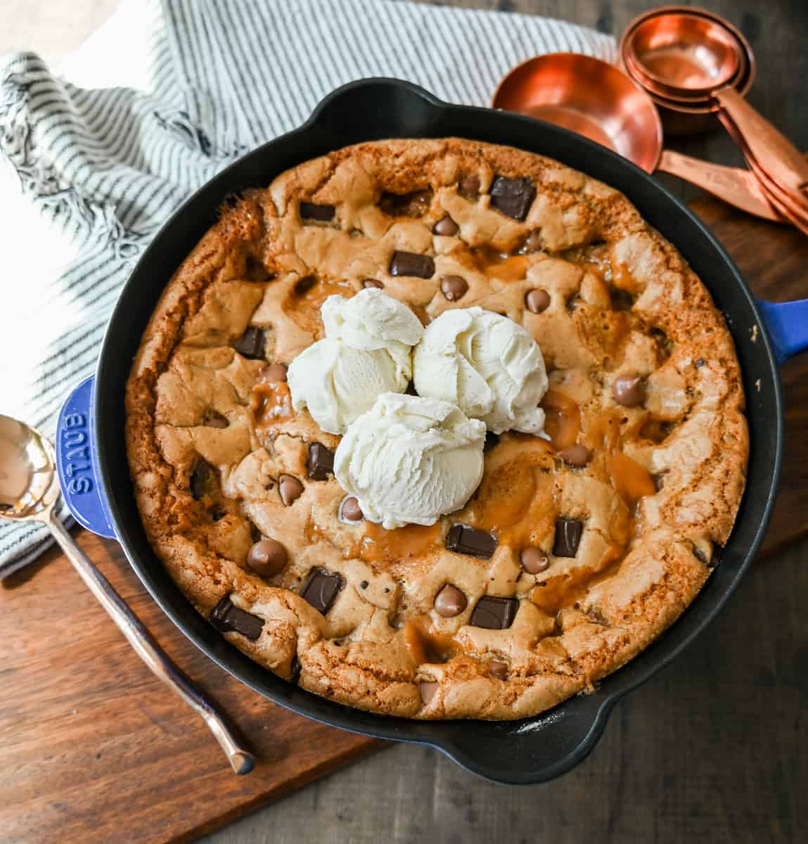 This salted caramel chocolate skillet cookie baked in a cast iron skillet and topped with vanilla ice cream has the perfect combination of sweet and salty caramel, and decadent chocolate in a perfectly buttery cookie.