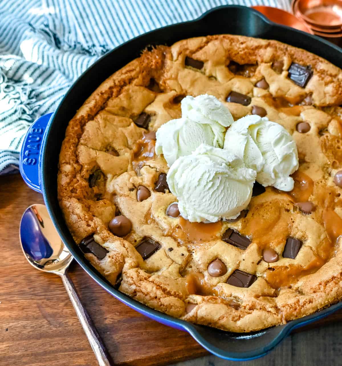 This salted caramel chocolate skillet cookie baked in a cast iron skillet and topped with vanilla ice cream has the perfect combination of sweet and salty caramel, and decadent chocolate in a perfectly buttery cookie.