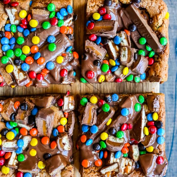 Candy Bar Cookie Bars. An ooey gooey cookie bar topped with an assortment of candy bars. The perfect candy bar blondie dessert to make with Halloween candy.