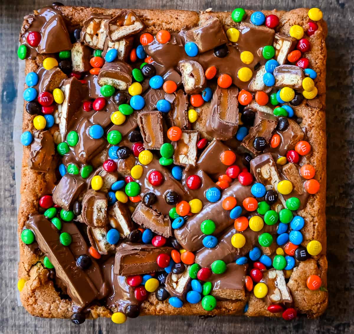 Candy Bar Cookie Bars. An ooey gooey cookie bar topped with an assortment of candy bars. The perfect candy bar blondie dessert to make with Halloween candy. 