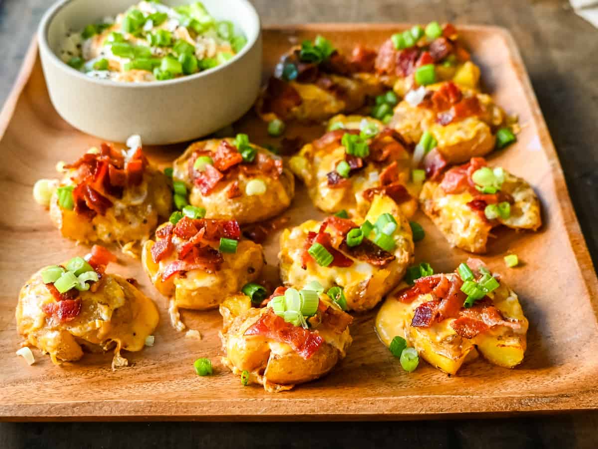 Loaded Bacon Cheddar Smashed Potatoes. These bacon cheddar loaded smashed potatoes start with crispy and buttery smashed potatoes topped with bacon, cheddar cheese, and green onions. These loaded smashed potatoes are the perfect side dish.