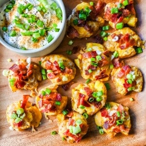 Loaded Bacon Cheddar Smashed Potatoes. These bacon cheddar loaded smashed potatoes start with crispy and buttery smashed potatoes topped with bacon, cheddar cheese, and green onions. These loaded smashed potatoes are the perfect side dish.