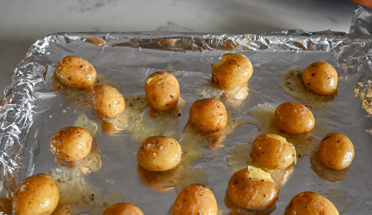 Loaded Bacon Cheddar Smashed Potatoes on baking sheet