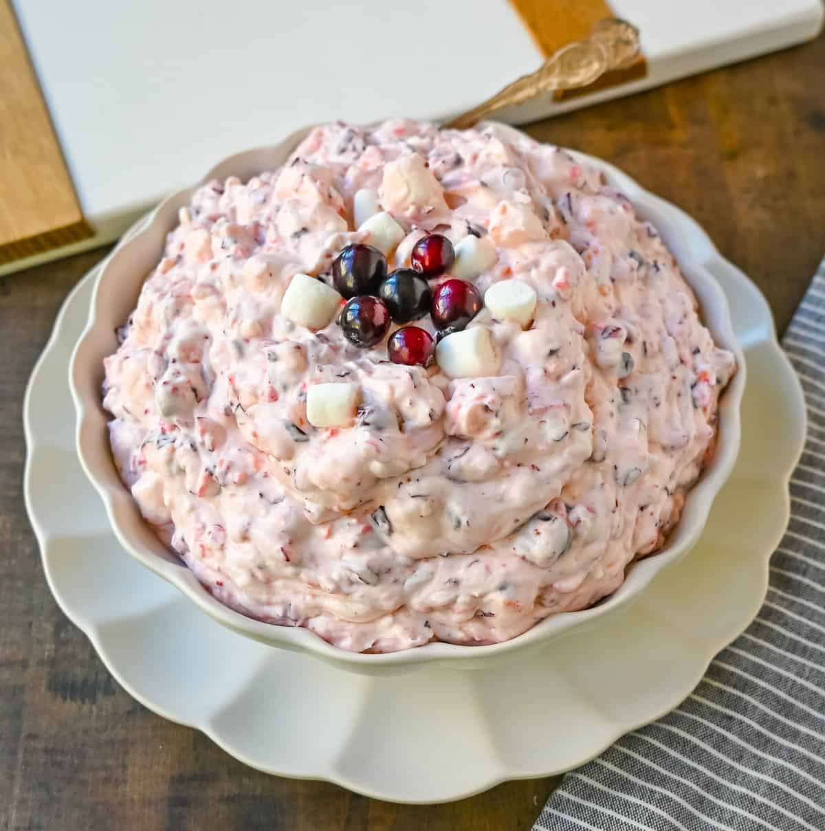 Cranberry Fluff Salad. This is such a popular holiday side dish! This easy cranberry salad is made with fresh cranberries, fresh pineapple, mini marshmallows, cream cheese, sugar, and fresh whipped cream. Perfectly sweet, tart, and creamy. This classic side dish recipe has been modernized and is better than ever!