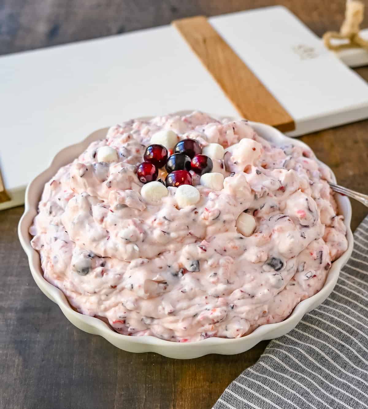 Cranberry Fluff Salad. This is such a popular holiday side dish! This easy cranberry salad is made with fresh cranberries, fresh pineapple, mini marshmallows, cream cheese, sugar, and fresh whipped cream. Perfectly sweet, tart, and creamy. This classic side dish recipe has been modernized and is better than ever!
