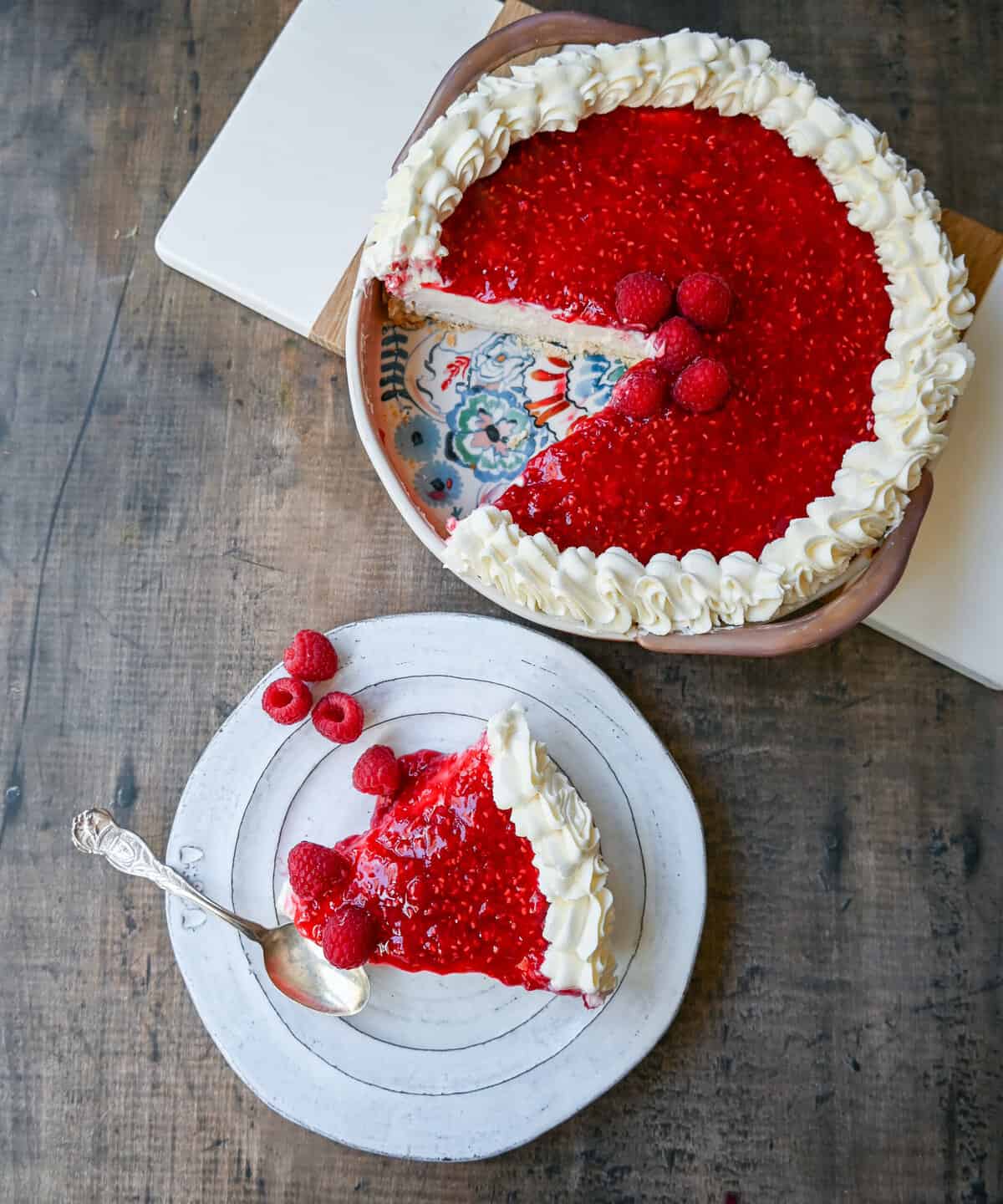 This Homemade Raspberry Cream Pie is made with a sweet luscious cream cheese filling and topped with a homemade raspberry sauce all in a homemade crust. This No-Bake Raspberry Cream Cheese Pie will become one of your absolute favorites!