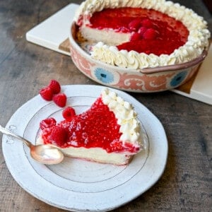 This Homemade Raspberry Cream Pie is made with a sweet luscious cream cheese filling and topped with a homemade raspberry sauce all in a homemade crust. This No-Bake Raspberry Cream Cheese Pie will become one of your absolute favorites!