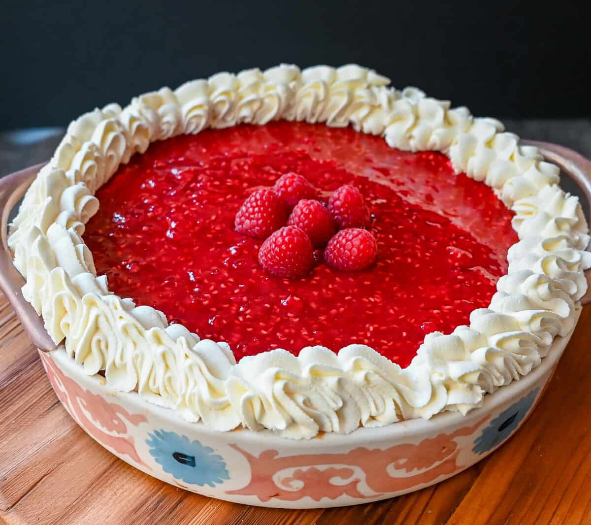 This Homemade Raspberry Cream Pie is made with a sweet luscious cream cheese filling and topped with a homemade raspberry sauce all in a homemade crust. This No-Bake Raspberry Cream Cheese Pie will become one of your absolute favorites!
