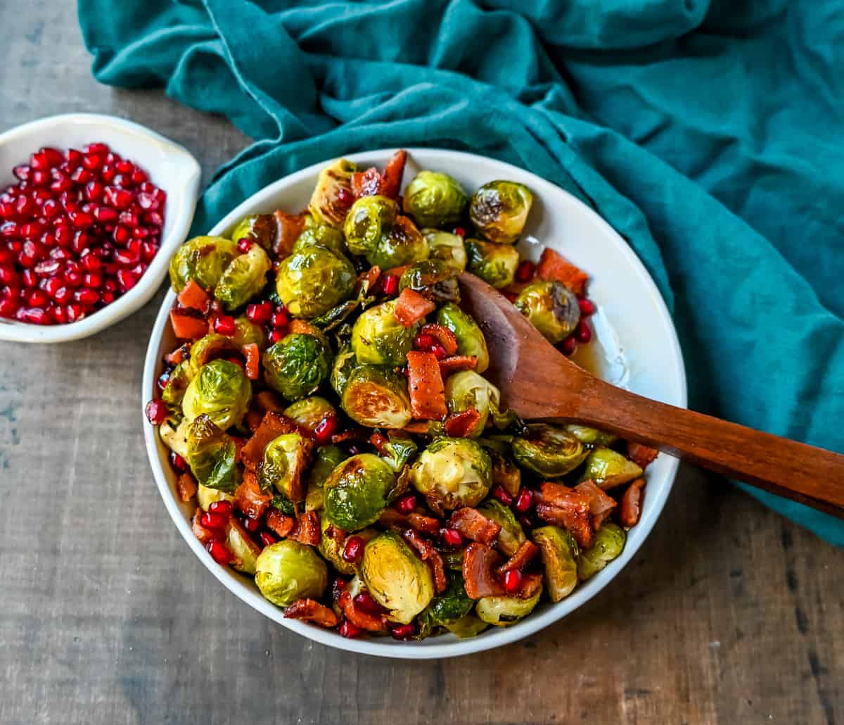 Roasted Brussels Sprouts with Bacon. These Roasted Brussels Sprouts are tossed in extra-virgin olive oil and spices and cooked until soft on the inside and crispy on the outside then drizzled with real maple syrup and served with crispy bacon and crunchy pomegranates. The perfect Fall and holiday side dish recipe.