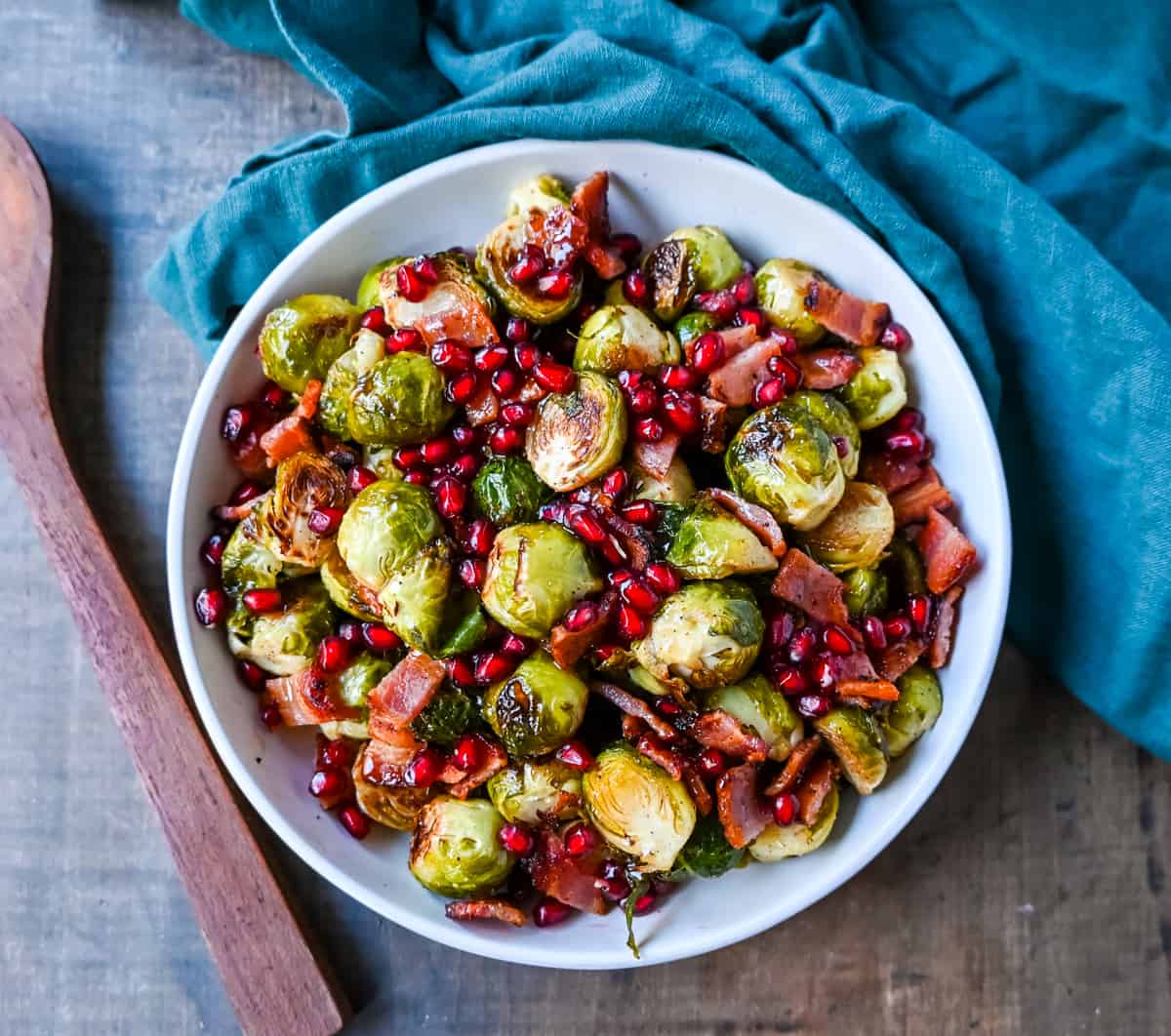 Roasted Brussels Sprouts with Bacon. These Roasted Brussels Sprouts are tossed in extra-virgin olive oil and spices and cooked until soft on the inside and crispy on the outside then drizzled with real maple syrup and served with crispy bacon and crunchy pomegranates. The perfect Fall and holiday side dish recipe.