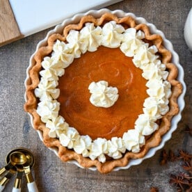 This Southern Sweet Potato Pie has the creamiest, spiced brown sugar sweet potato filling in a buttery crust and topped with fresh whipped cream. This is the perfect Fall and Thanksgiving dessert.