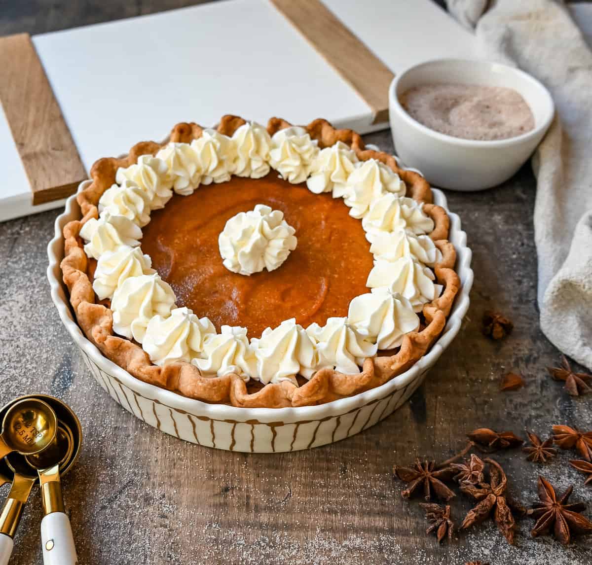 This Southern Sweet Potato Pie has the creamiest, spiced brown sugar sweet potato filling in a buttery crust and topped with fresh whipped cream. This is the perfect Fall and Thanksgiving dessert.