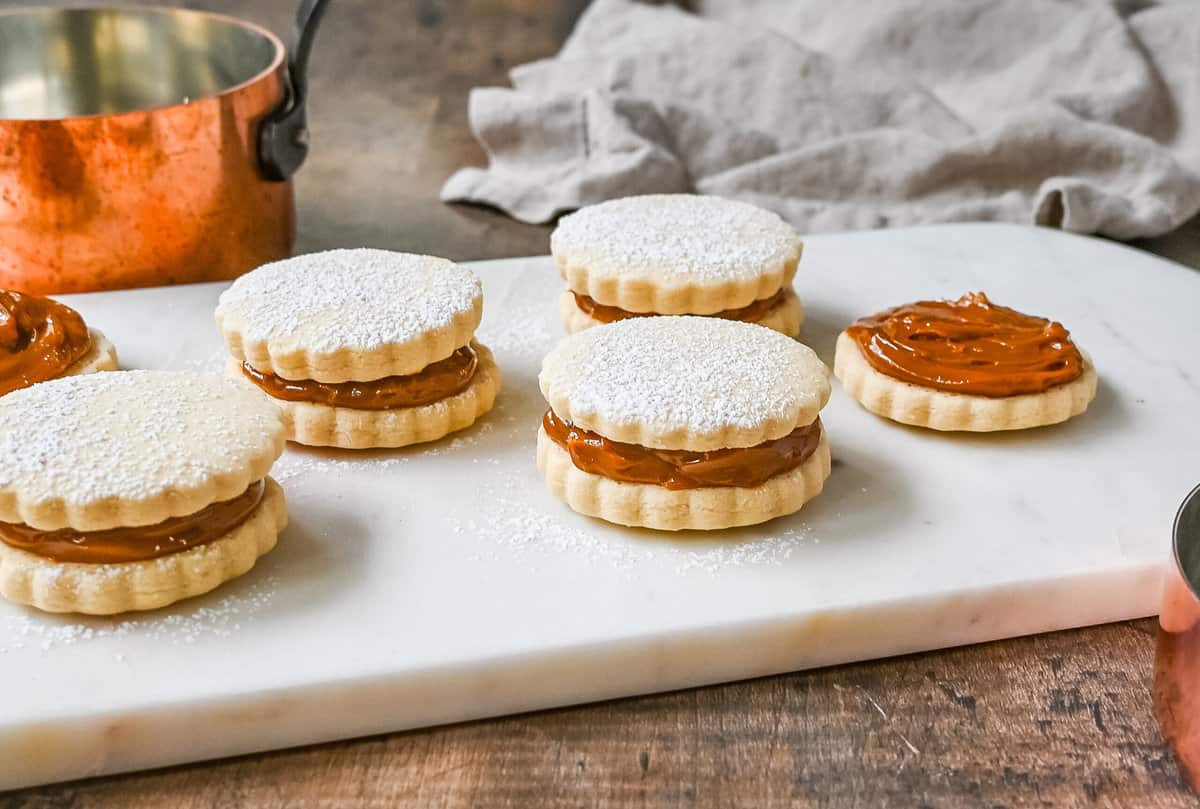 Alfajores Dulce de Leche Sandwich Cookies. These alfajores are a popular sandwich cookie around the world are made with two soft and buttery shortbread cookies filled with rich dulce de leche filling. 