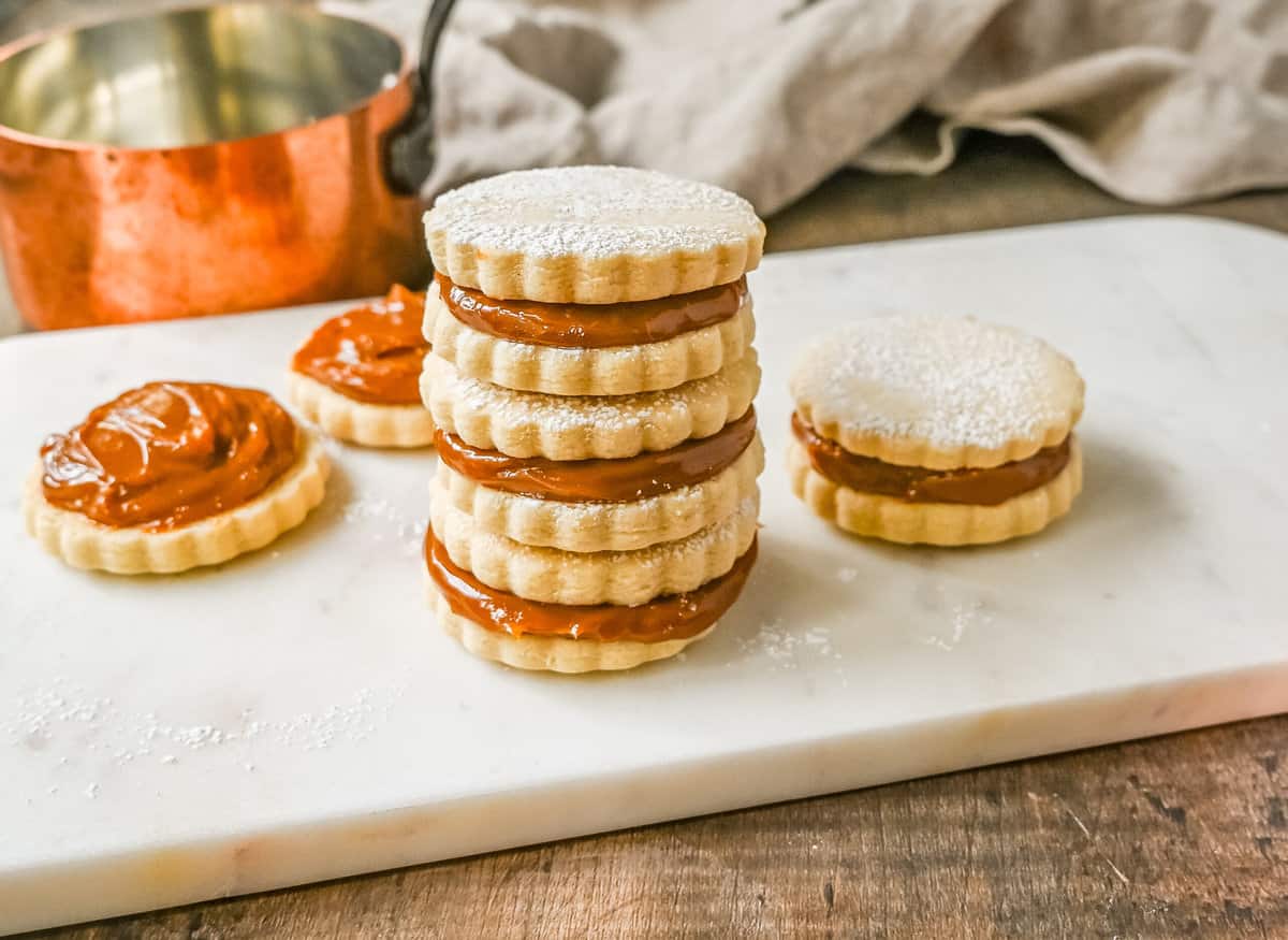 Alfajores Dulce de Leche Sandwich Cookies. These alfajores are a popular sandwich cookie around the world are made with two soft and buttery shortbread cookies filled with rich dulce de leche filling. 