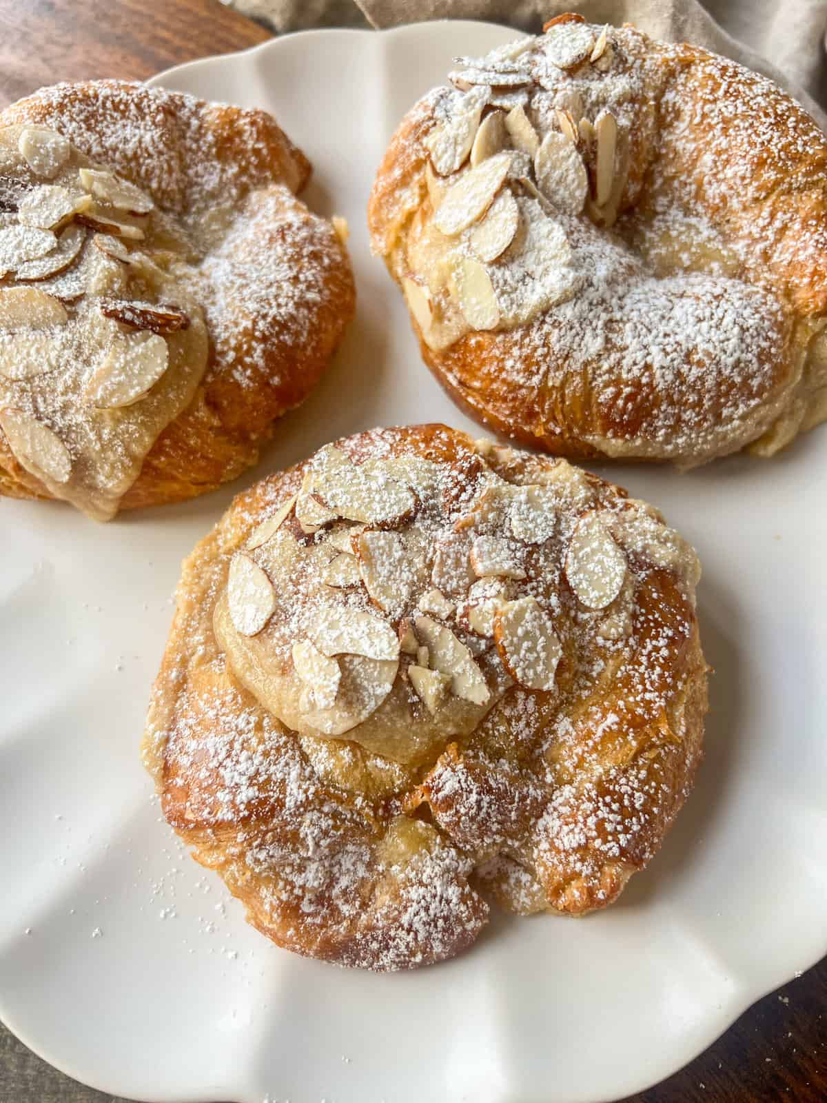 Easy Almond Croissants. How to make the easiest homemade almond croissants ever! These buttery, flaky croissants filled with a homemade almond filling and topped with crunchy almonds will rival any bakery. You can make these bakery-style almond croissants in 25 minutes!