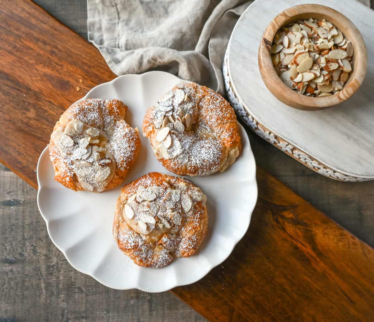 Easy Almond Croissants. How to make the easiest homemade almond croissants ever! These buttery, flaky croissants filled with a homemade almond filling and topped with crunchy almonds will rival any bakery. You can make these bakery-style almond croissants in 25 minutes!