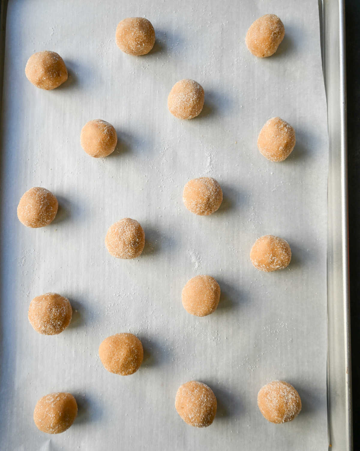 Peanut butter blossom cookie dough rolled into balls and sugar