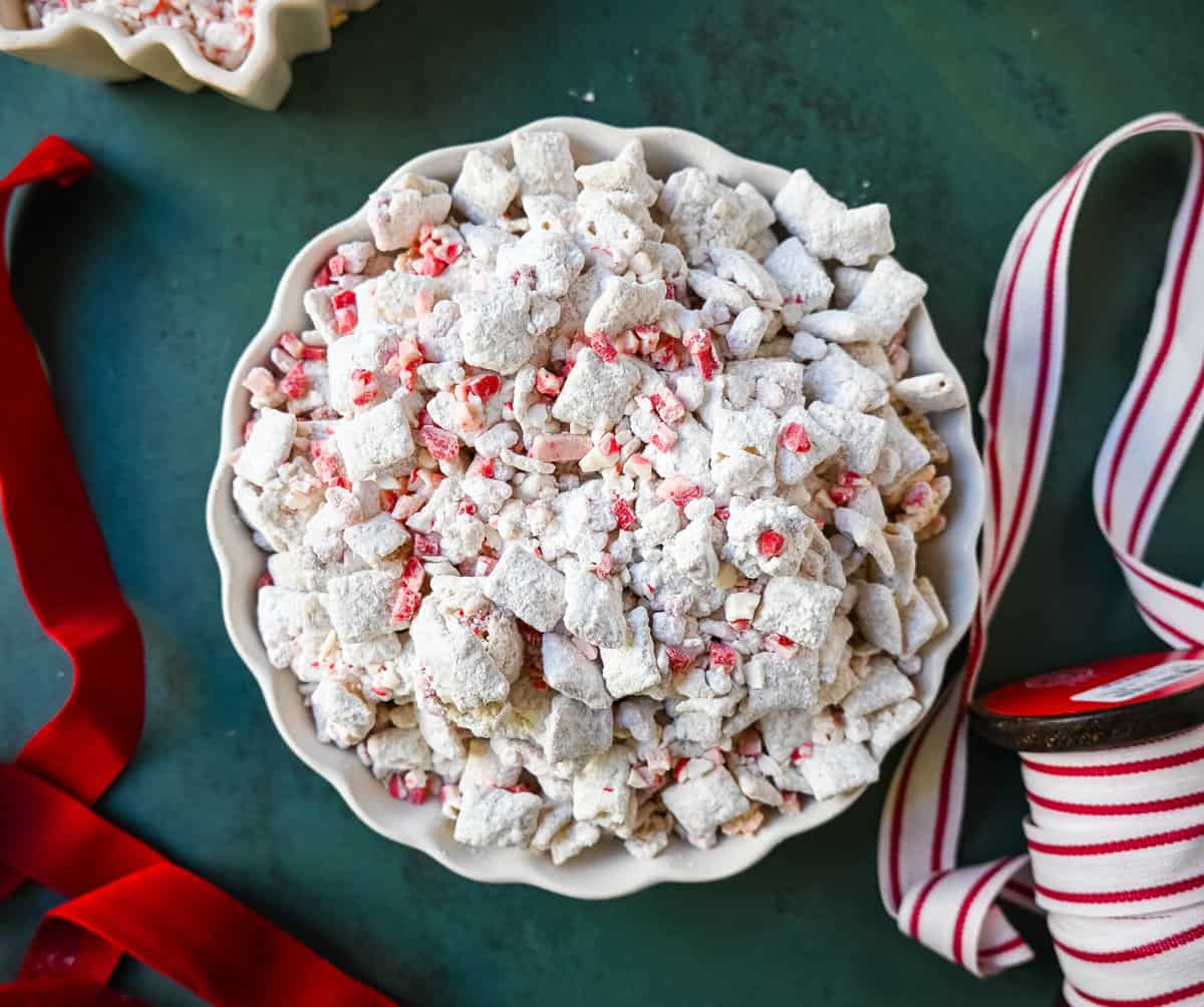 Peppermint Puppy Chow, also known as Peppermint Muddy Buddies, Peppermint Chex Mix, or Peppermint Bark Muddy Buddies, is a festive and addictive holiday treat. It is a variation of the classic Muddy Buddies, but is made with Rice Chex cereal, white chocolate, peppermint bark or candy canes, and powdered sugar. 