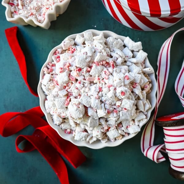 Peppermint Puppy Chow, also known as Peppermint Muddy Buddies, Peppermint Chex Mix, or Peppermint Bark Muddy Buddies, is a festive and addictive holiday treat. It is a variation of the classic Muddy Buddies, but is made with Rice Chex cereal, white chocolate, peppermint bark or candy canes, and powdered sugar.