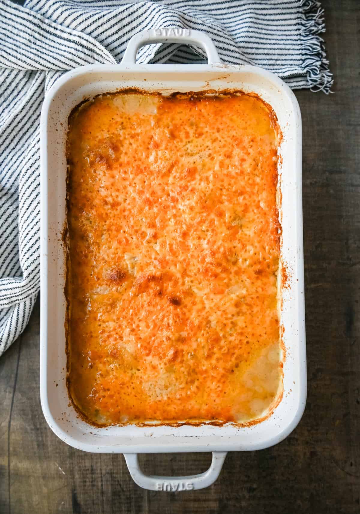 Cheesy Scalloped Potatoes. These creamy, cheesy scalloped potatoes are the perfect side dish and are made with thinly sliced potatoes, a decadent bechamel sauce, and layers upon layers of cheese and baked until melted and bubbly.