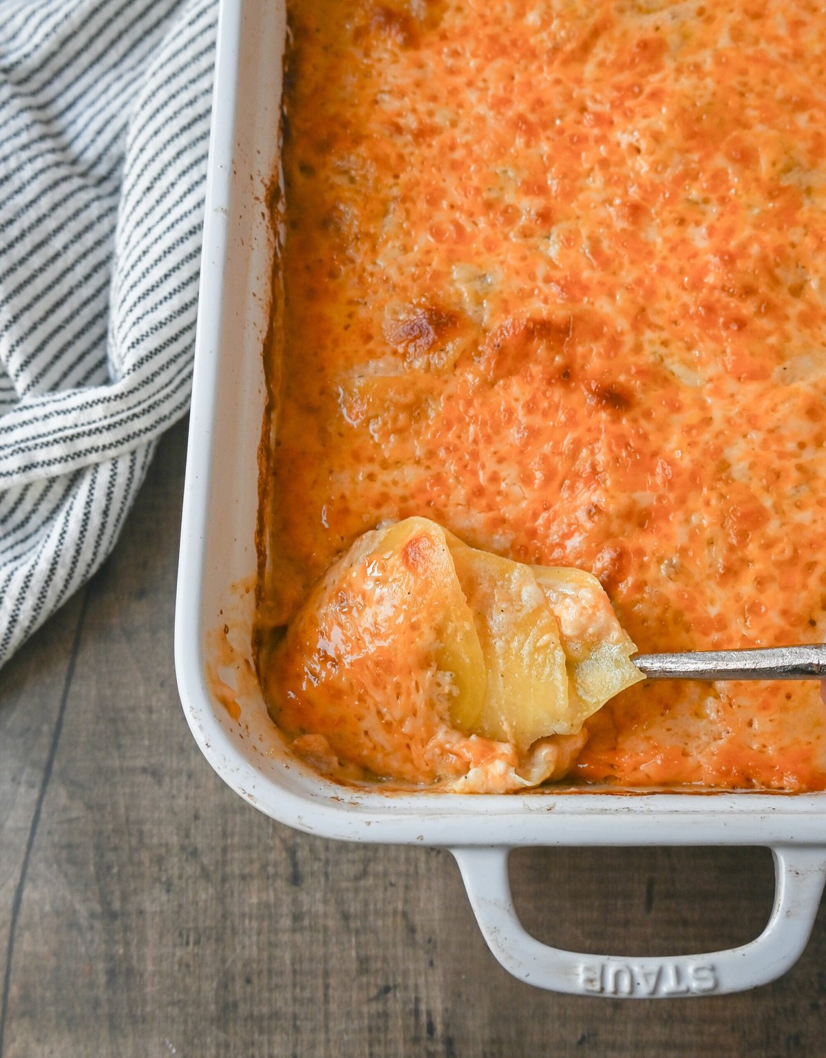 Cheesy Scalloped Potatoes. These creamy, cheesy scalloped potatoes are the perfect side dish and are made with thinly sliced potatoes, a decadent bechamel sauce, and layers upon layers of cheese and baked until melted and bubbly.