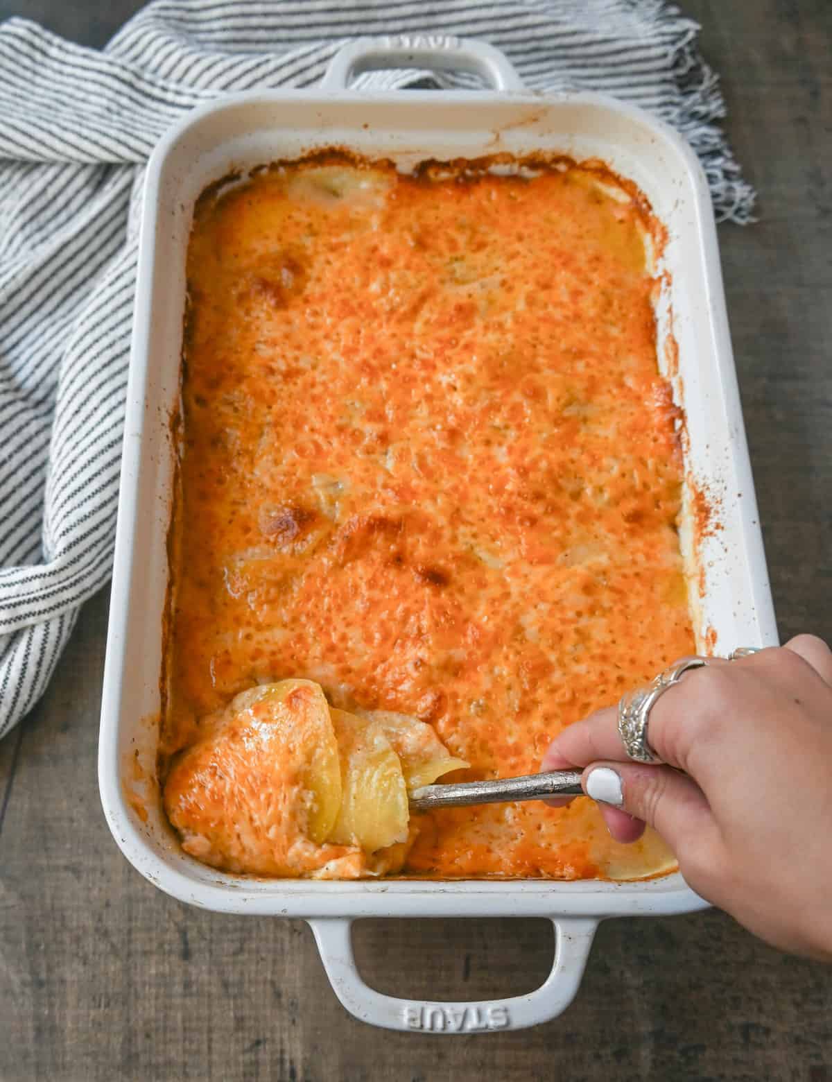 Cheesy Scalloped Potatoes. These creamy, cheesy scalloped potatoes are the perfect side dish and are made with thinly sliced potatoes, a decadent bechamel sauce, and layers upon layers of cheese and baked until melted and bubbly.