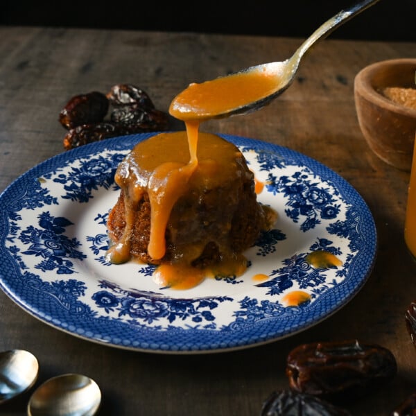 Sticky Toffee Pudding. A famous English dessert with a moist sponge cake covered in homemade caramel toffee sauce and vanilla ice cream. This is a beautiful Christmas dessert recipe.